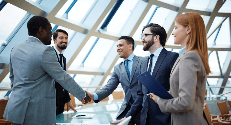 Lawyers and clients exchanging handshakes, smiling after a favorable outcome in a construction litigation case, showcasing the commitment to success and client satisfaction at a leading law firm.
