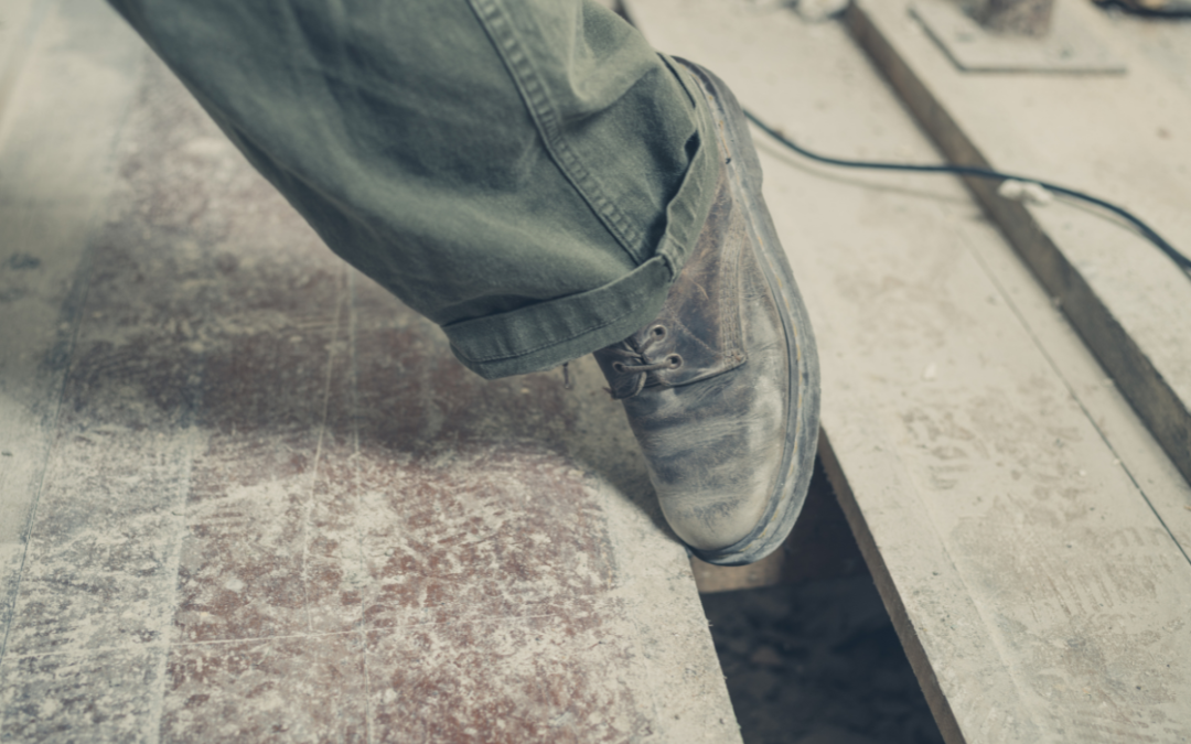 Man tripping on a floorboard earning a complex personal injury due to a construction defect.